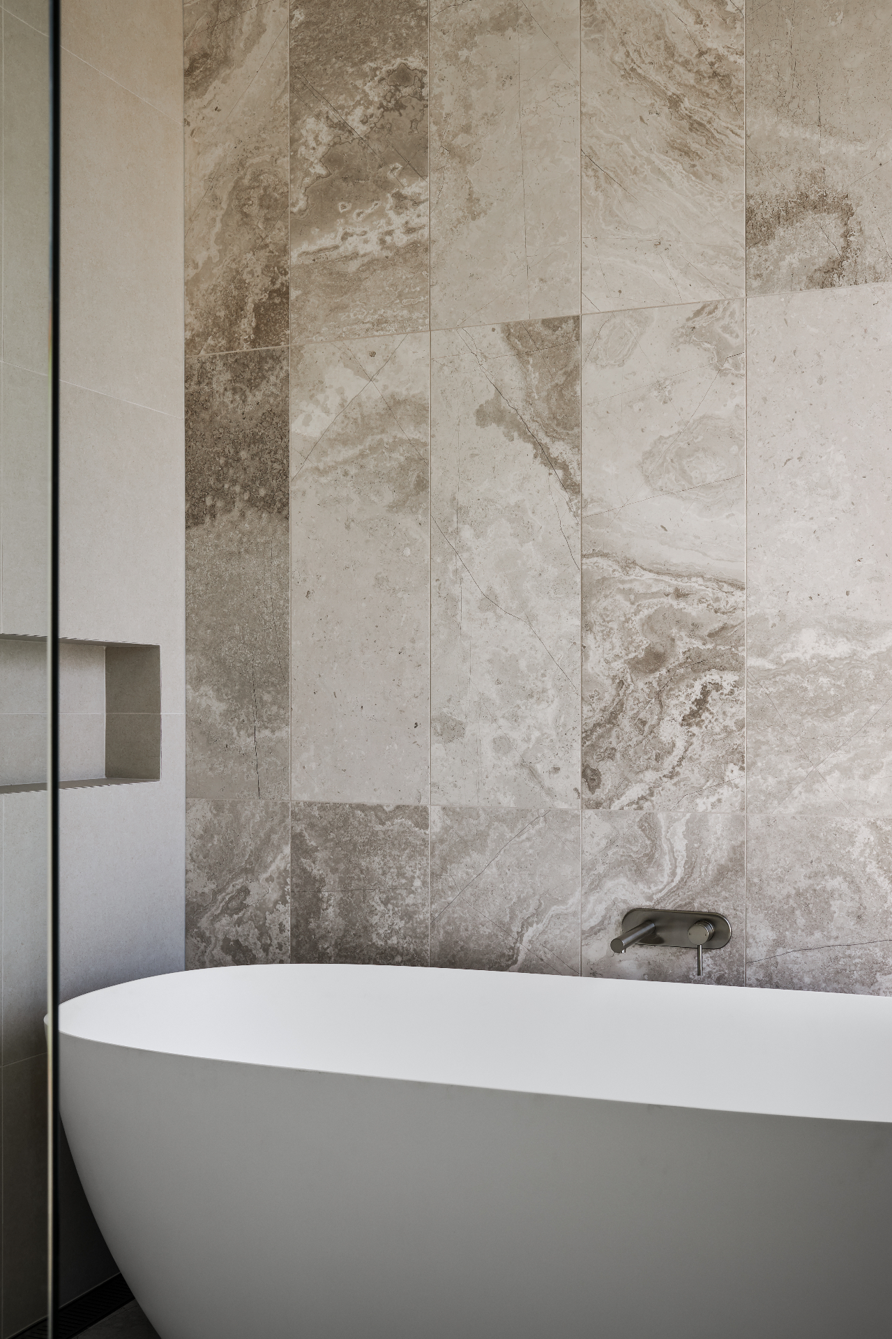 Travertine bathroom with stone bath