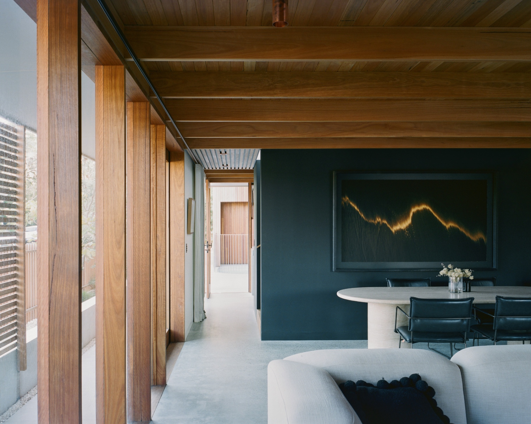 Dining, against the green wall