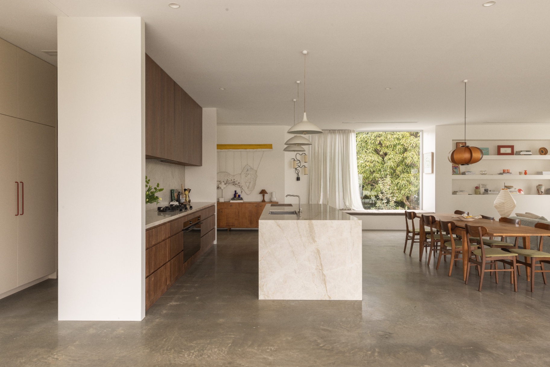 Kitchen island and dining beyond