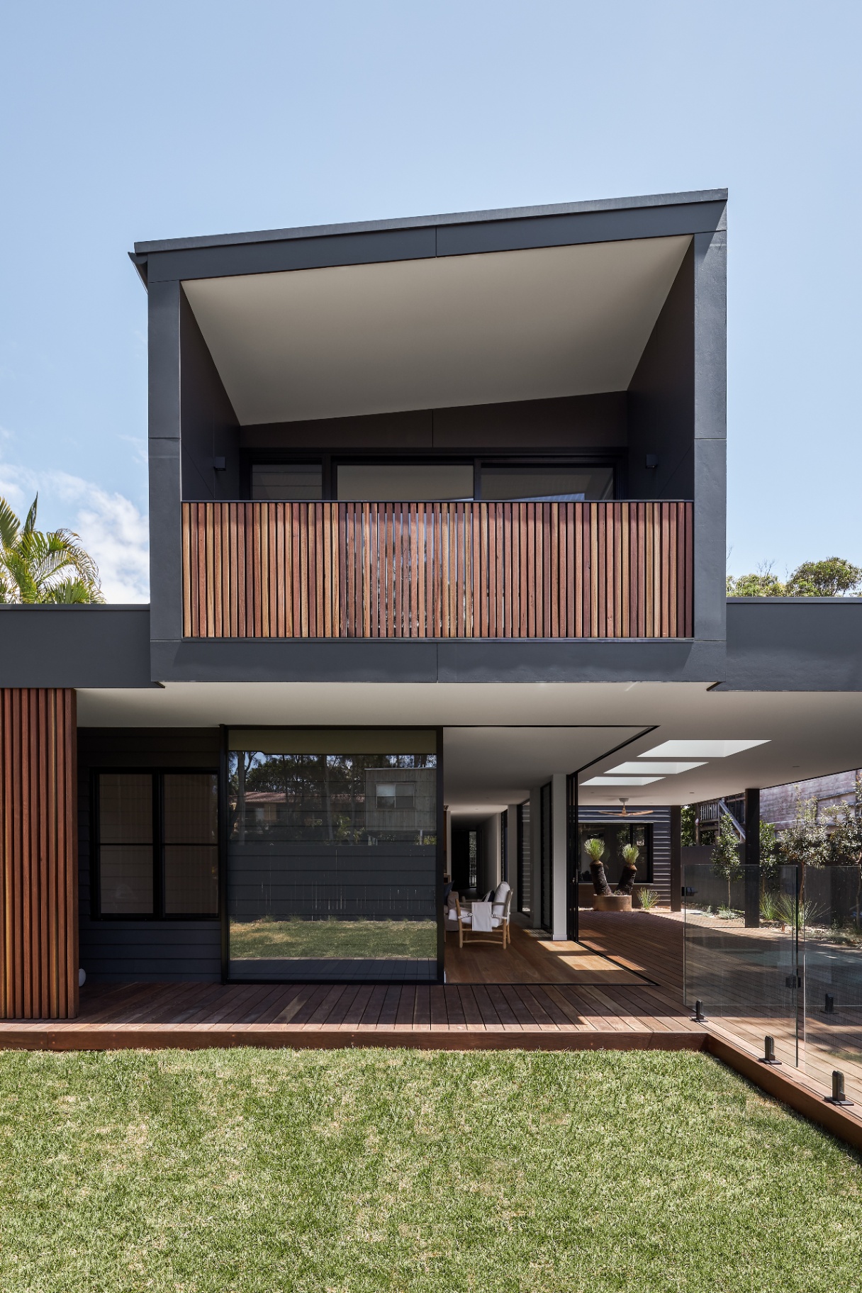 Rear facade, lawn, and covered deck